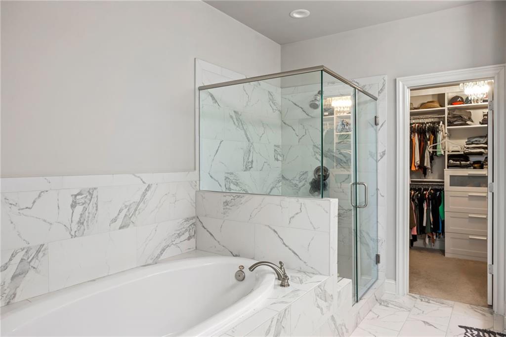 1799 Falling Sky Court Atlanta, GA 30319 - Photo 14 of 26 a bathroom with a bathtub and a shower