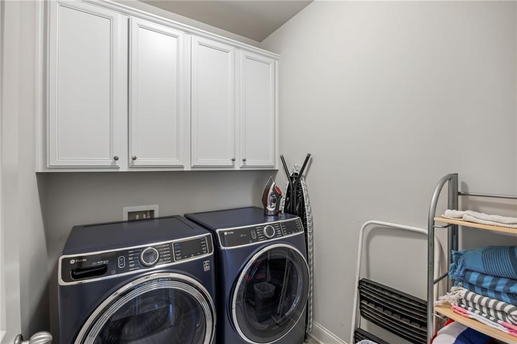 1799 Falling Sky Court Atlanta, GA 30319 - Photo 22 of 26 a view of storage and utility room with washer and dryer