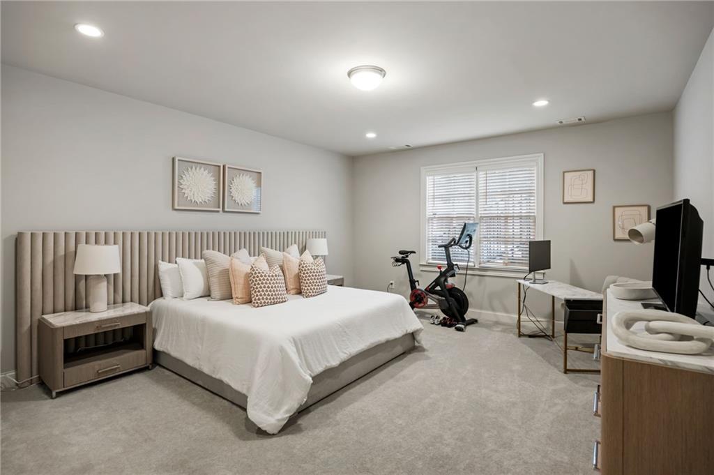 1799 Falling Sky Court Atlanta, GA 30319 - Photo 23 of 26 a bedroom with a bed and a tv
