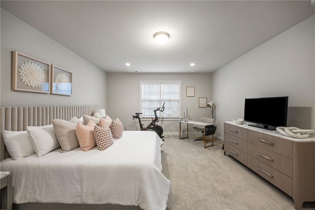 1799 Falling Sky Court Atlanta, GA 30319 - Photo 25 of 26 a hotel room with bed and a flat screen tv