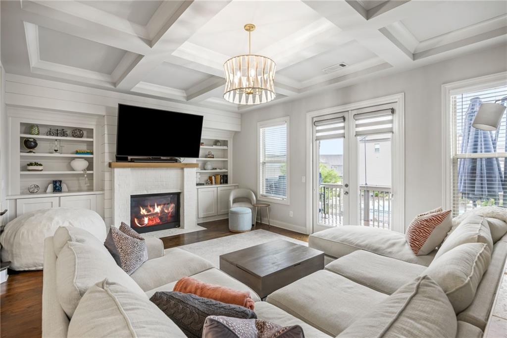 1799 Falling Sky Court Atlanta, GA 30319 - Photo 7 of 26 a living room with furniture a fireplace and a flat screen tv