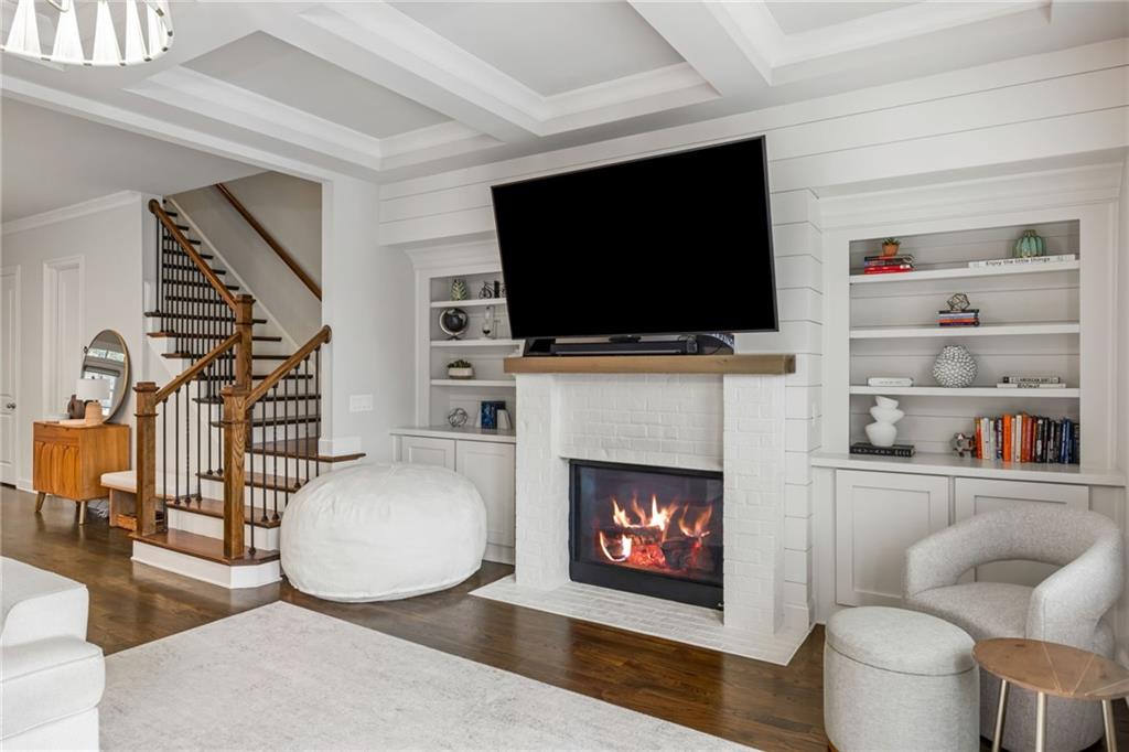 1799 Falling Sky Court Atlanta, GA 30319 - Photo 9 of 26 a living room with furniture a flat screen tv and a fireplace