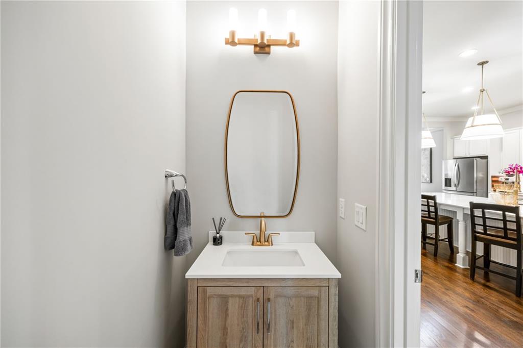1799 Falling Sky Court Atlanta, GA 30319 - Photo 10 of 26 a bathroom with a sink a mirror and vanity