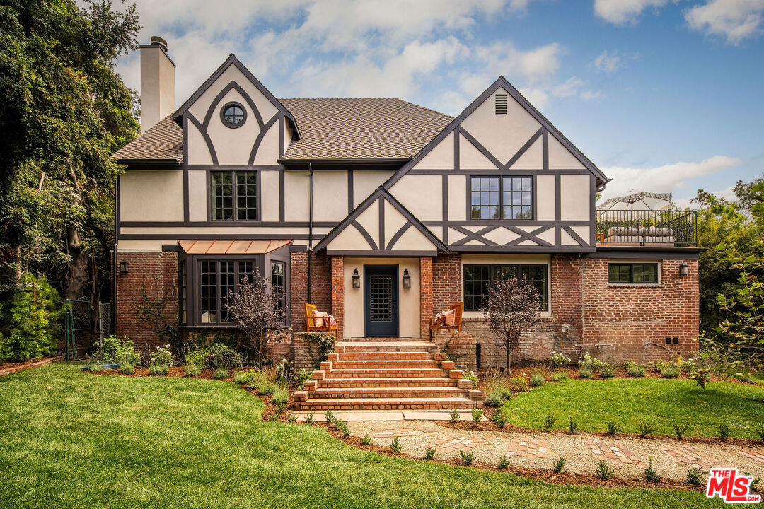a front view of a house with garden