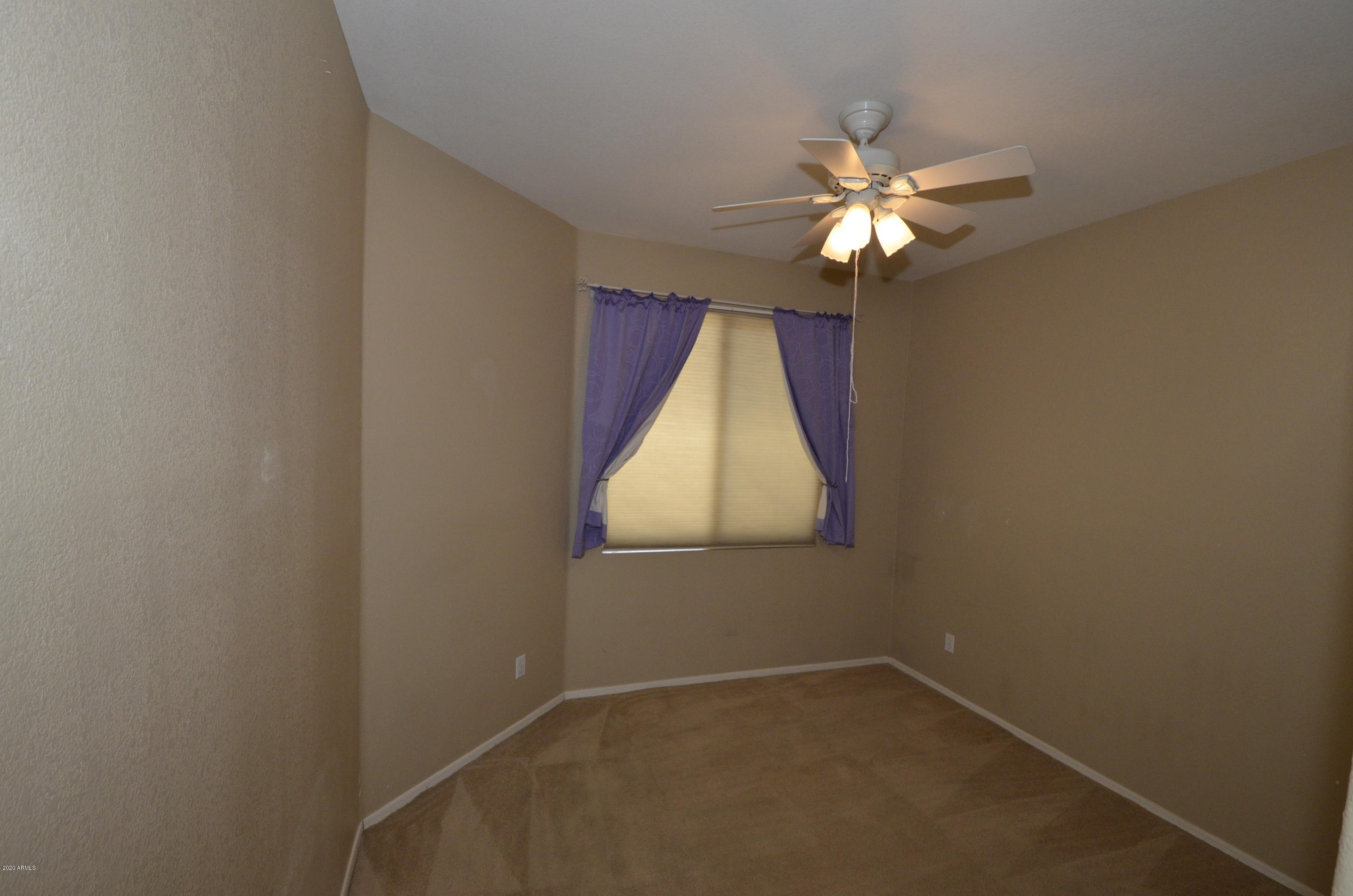 1148 South Roca Street Gilbert, AZ 85296 - Photo 15 of 20 an empty room with windows and fan