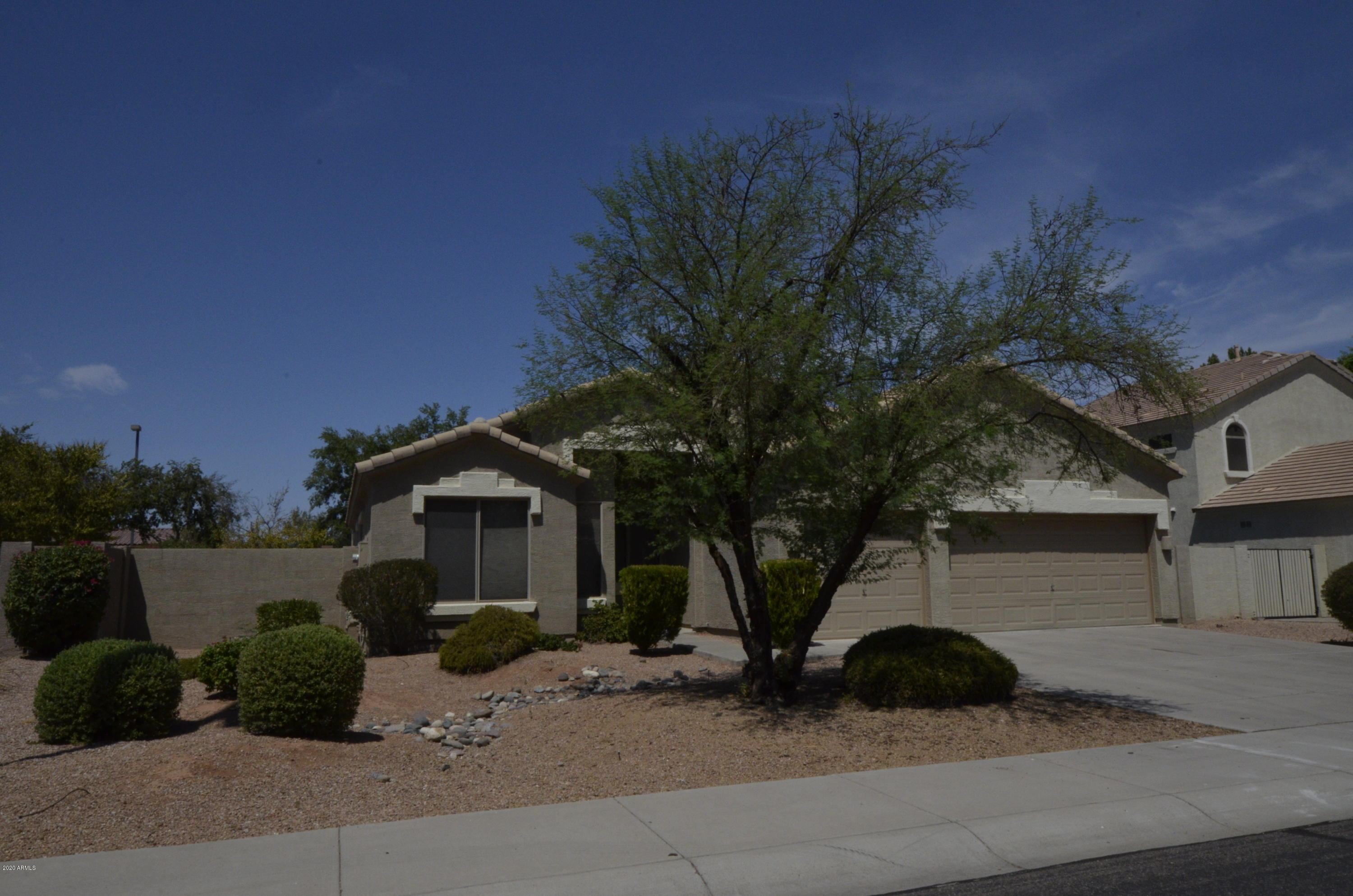 1148 South Roca Street Gilbert, AZ 85296 - Photo 2 of 20 a view of a house with a tree in front of it