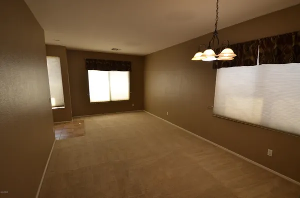 a view of a room with a chandelier fan and fire place