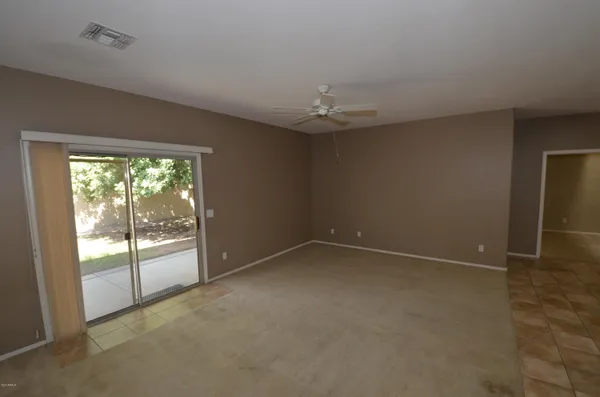 an empty room with a empty space and windows