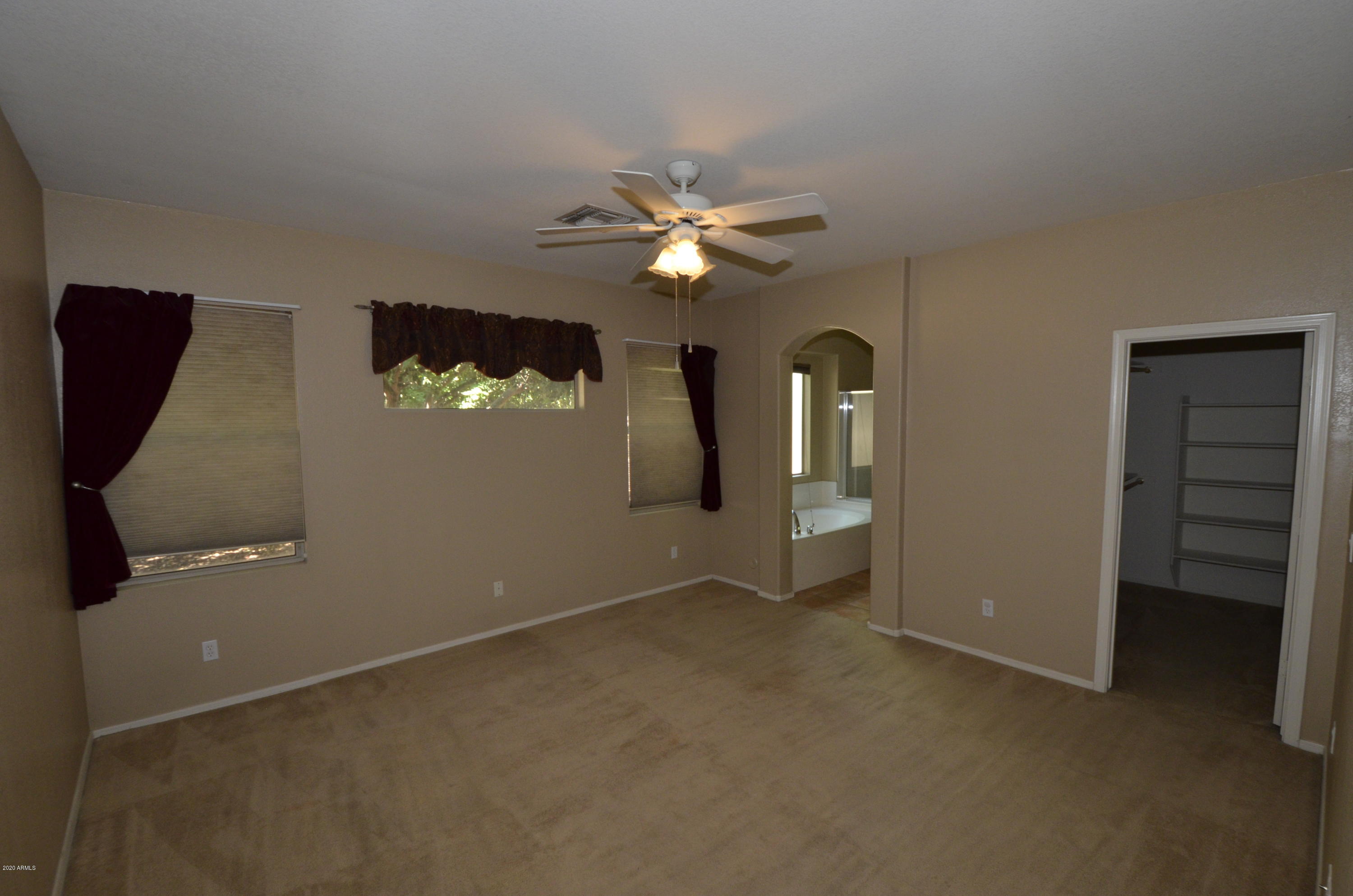 1148 South Roca Street Gilbert, AZ 85296 - Photo 10 of 20 wooden floor in an empty room with a window