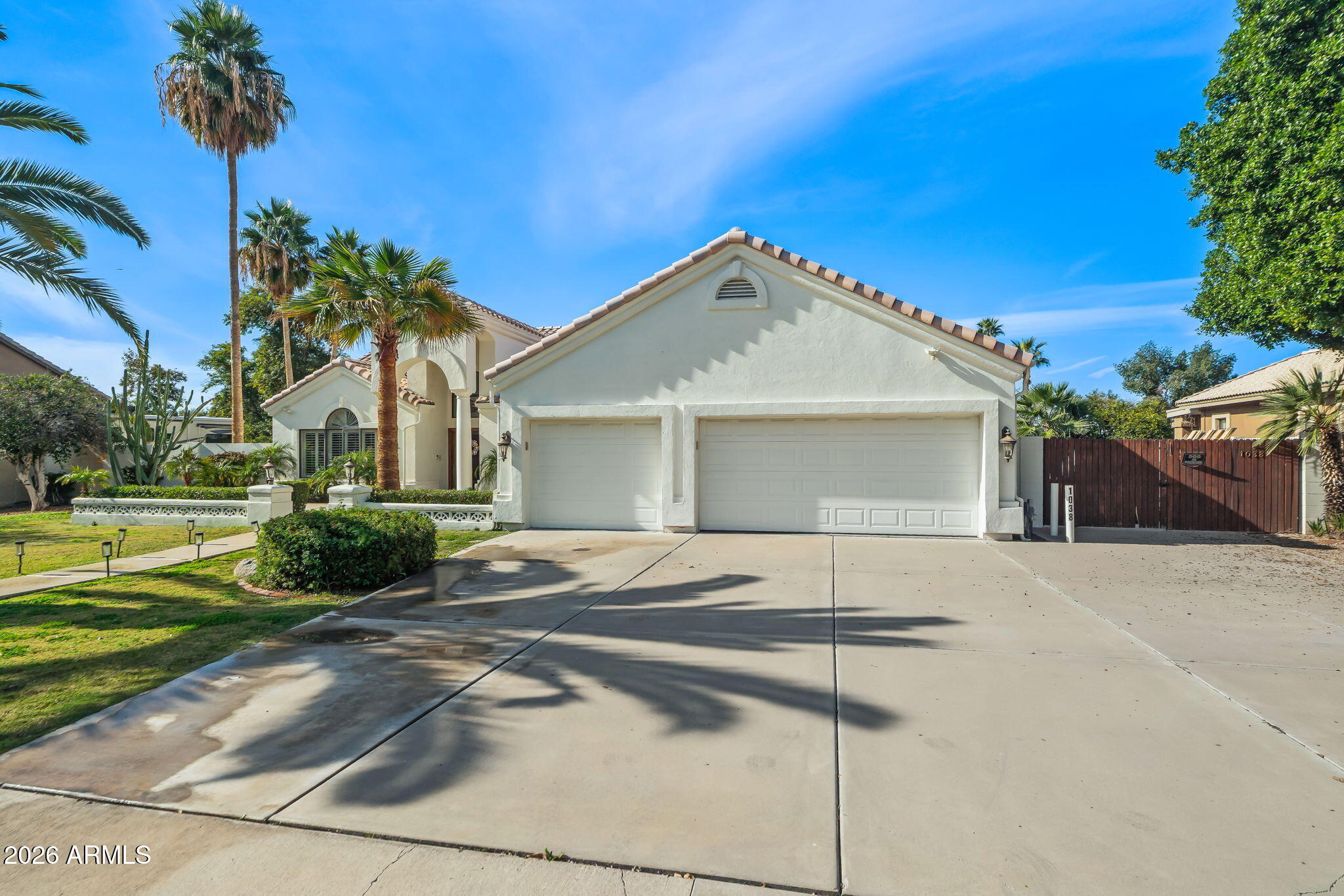 1038 South 38th Street Mesa, AZ 85206 - Photo 3 of 59 a front view of a house with a yard and potted plants
