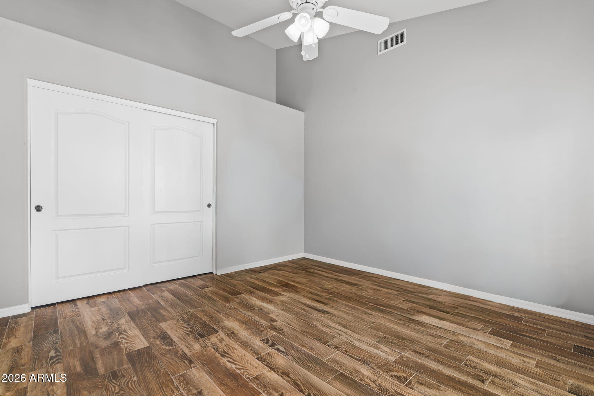 1038 South 38th Street Mesa, AZ 85206 - Photo 10 of 59 a view of a room with wooden floor and chandelier fan
