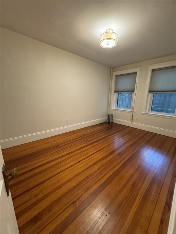 31 Westbourne Terrace, Unit 2 Brookline, MA 02446 - Photo 12 of 15 wooden floor in an empty room with a window