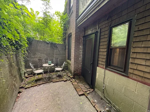 a backyard of a house with outdoor seating