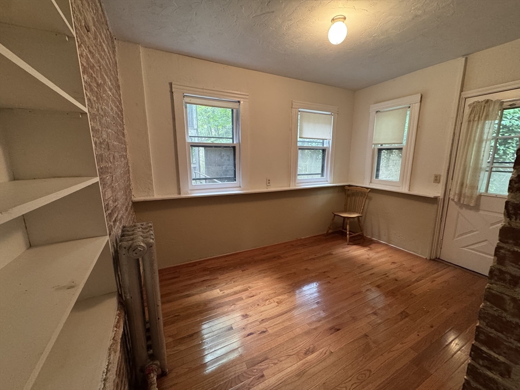 31 Westbourne Terrace, Unit 2 Brookline, MA 02446 - Photo 3 of 15 wooden floor in an empty room with a window