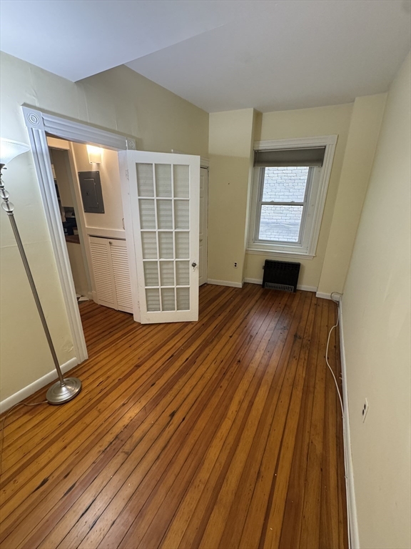 31 Westbourne Terrace, Unit 2 Brookline, MA 02446 - Photo 8 of 15 an empty room with wooden floor and windows