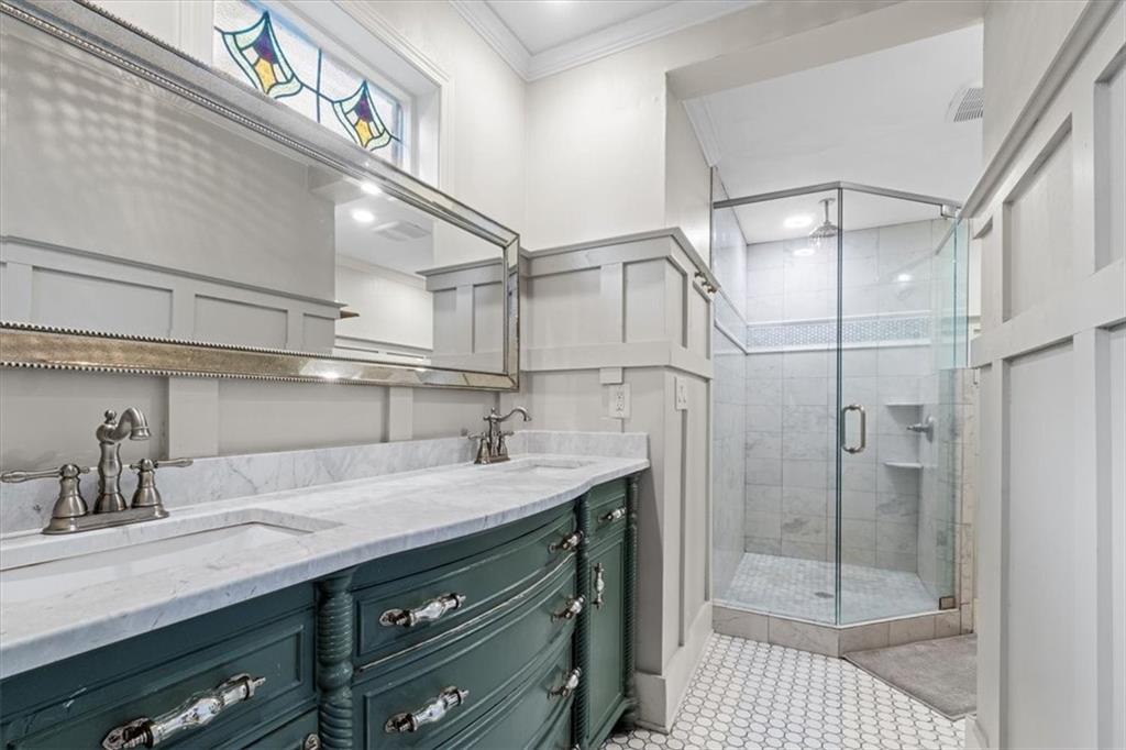 5143 Floyd Street Northeast Covington, GA 30014 - Photo 16 of 27 a bathroom with a sink a mirror and shower
