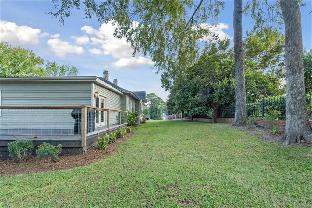 5143 Floyd Street Northeast Covington, GA 30014 - Photo 25 of 27 a backyard of a house with plants and large tree
