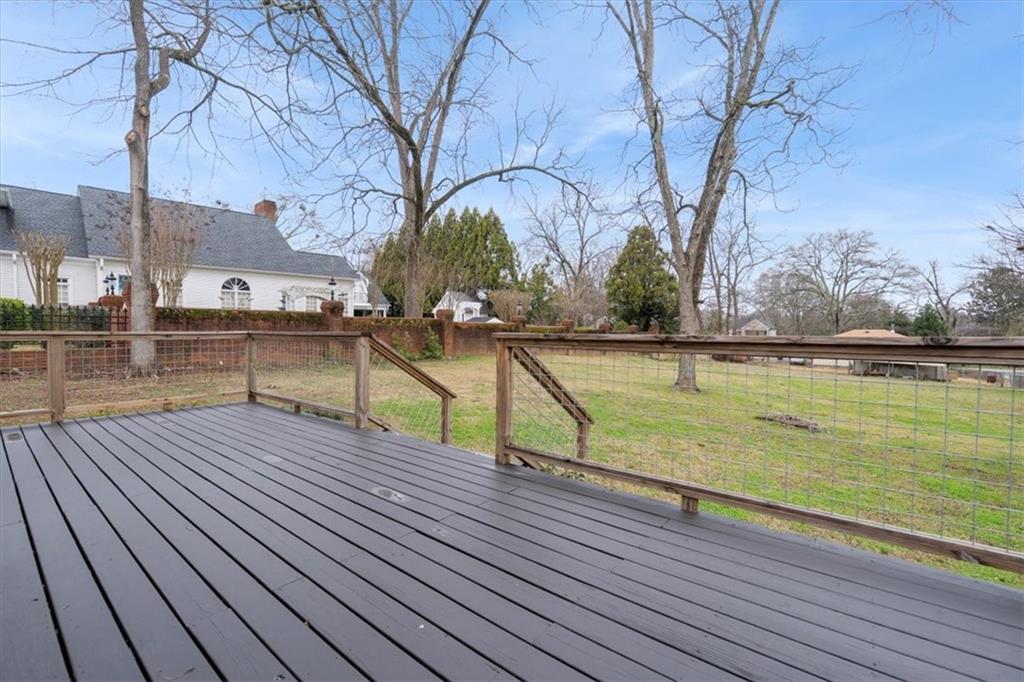 5143 Floyd Street Northeast Covington, GA 30014 - Photo 26 of 27 a view of a roof deck with wooden floor and fence