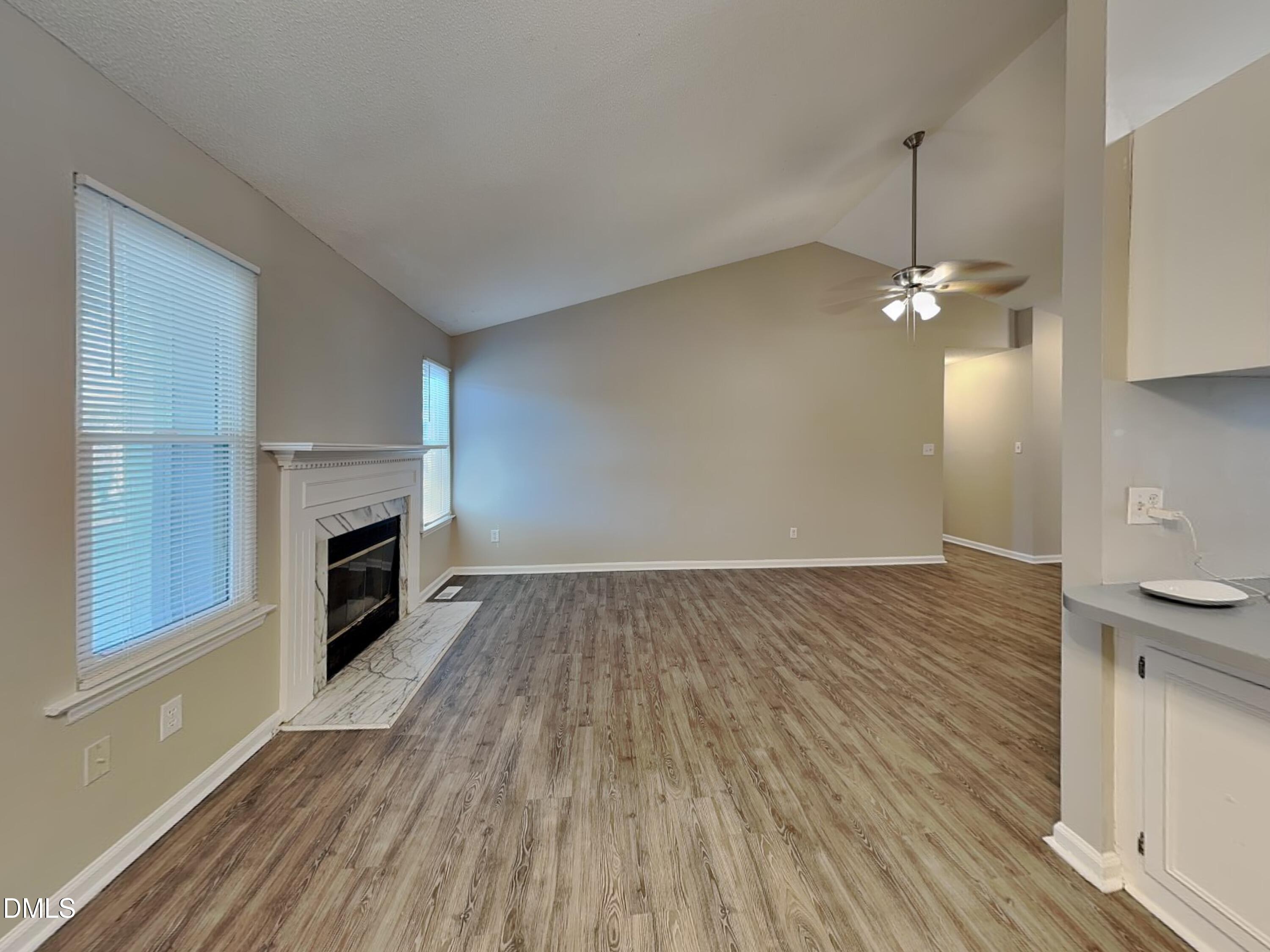 3520 Lytham Place Raleigh, NC 27604 - Photo 4 of 18 wooden floor in an empty room with a fireplace