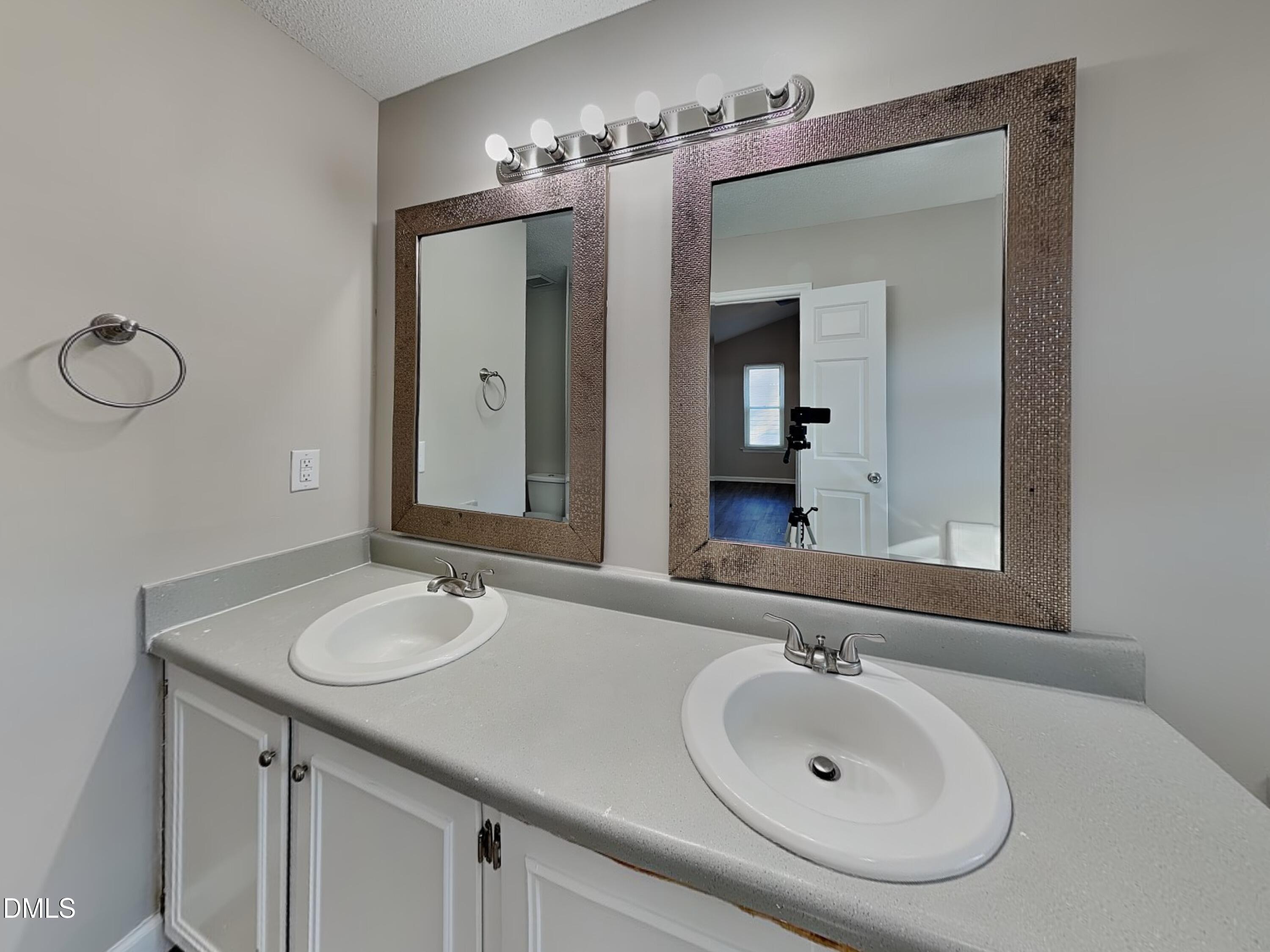 3520 Lytham Place Raleigh, NC 27604 - Photo 8 of 18 a bathroom with a sink and a mirror