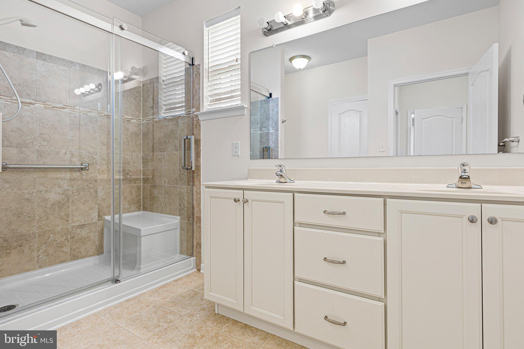 647 Vivaldi Drive Middletown, DE 19709 - Photo 11 of 38 a bathroom with a shower sink and mirror