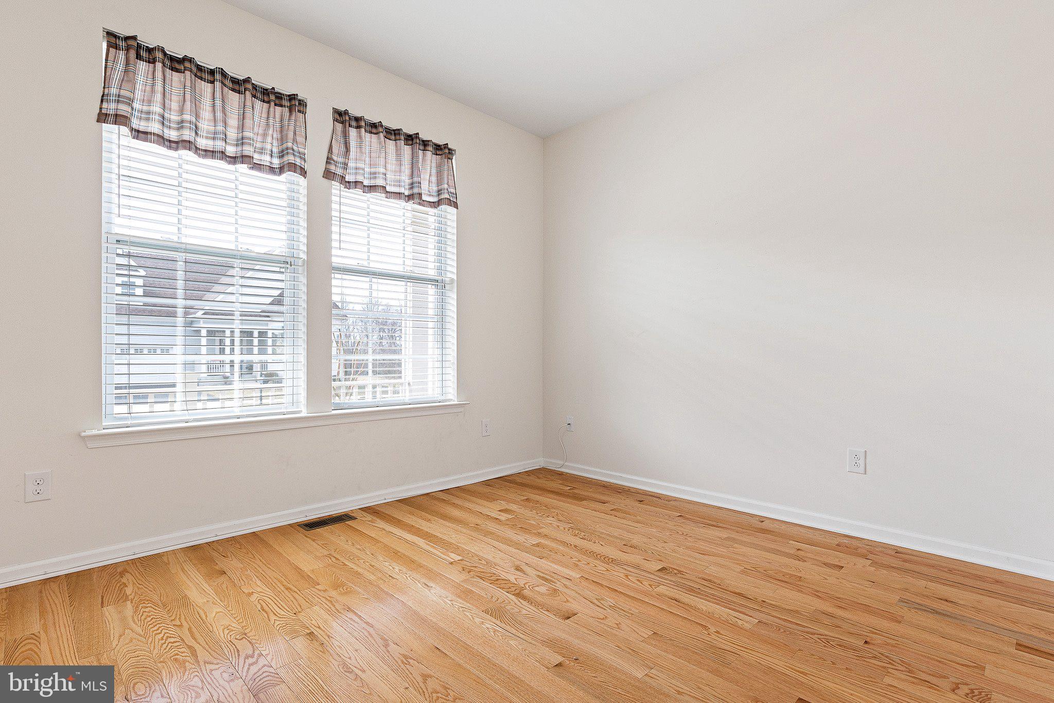 647 Vivaldi Drive Middletown, DE 19709 - Photo 12 of 38 a view of an empty room with wooden floor and a window