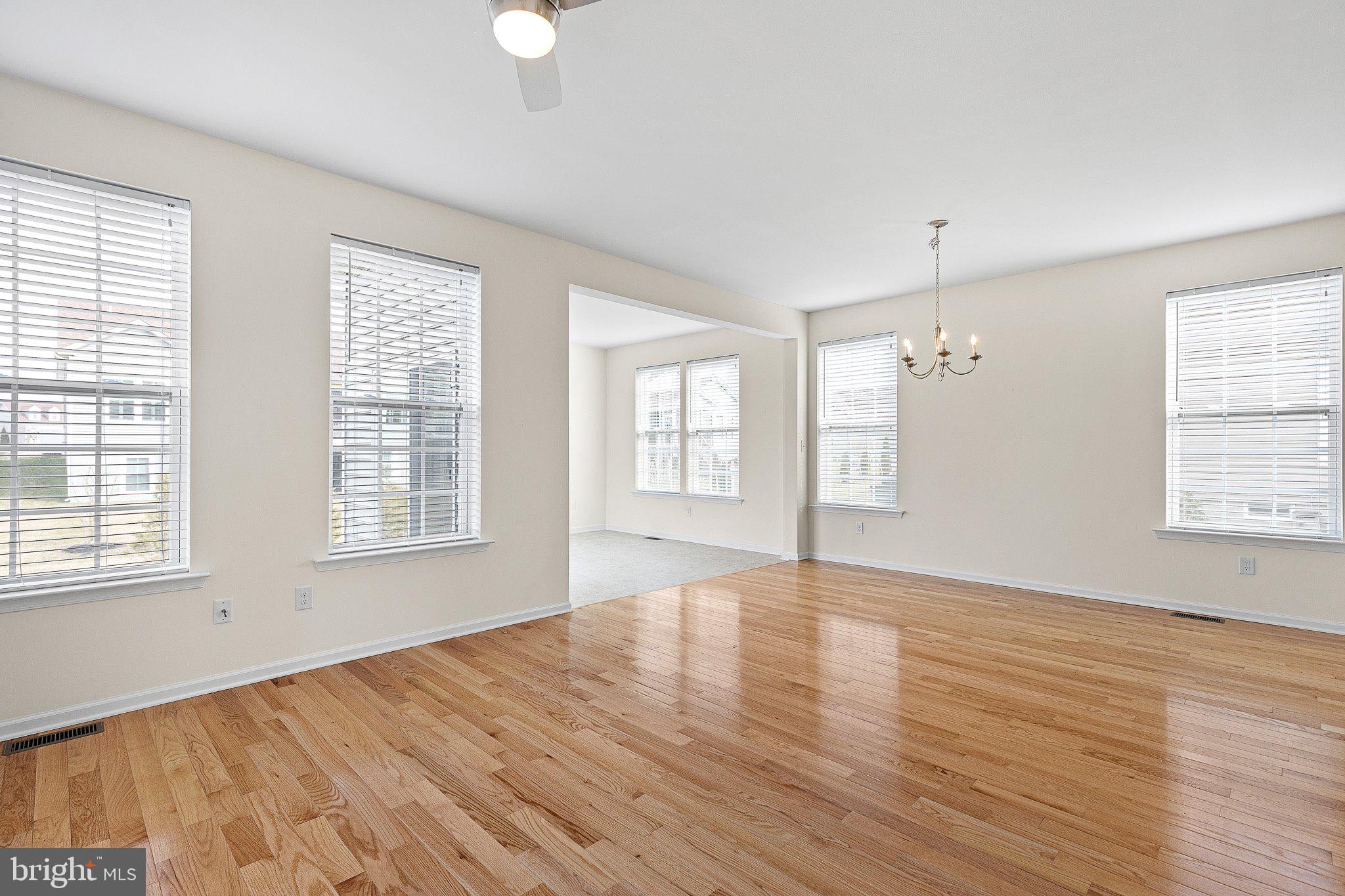 647 Vivaldi Drive Middletown, DE 19709 - Photo 16 of 38 an empty room with wooden floor and windows