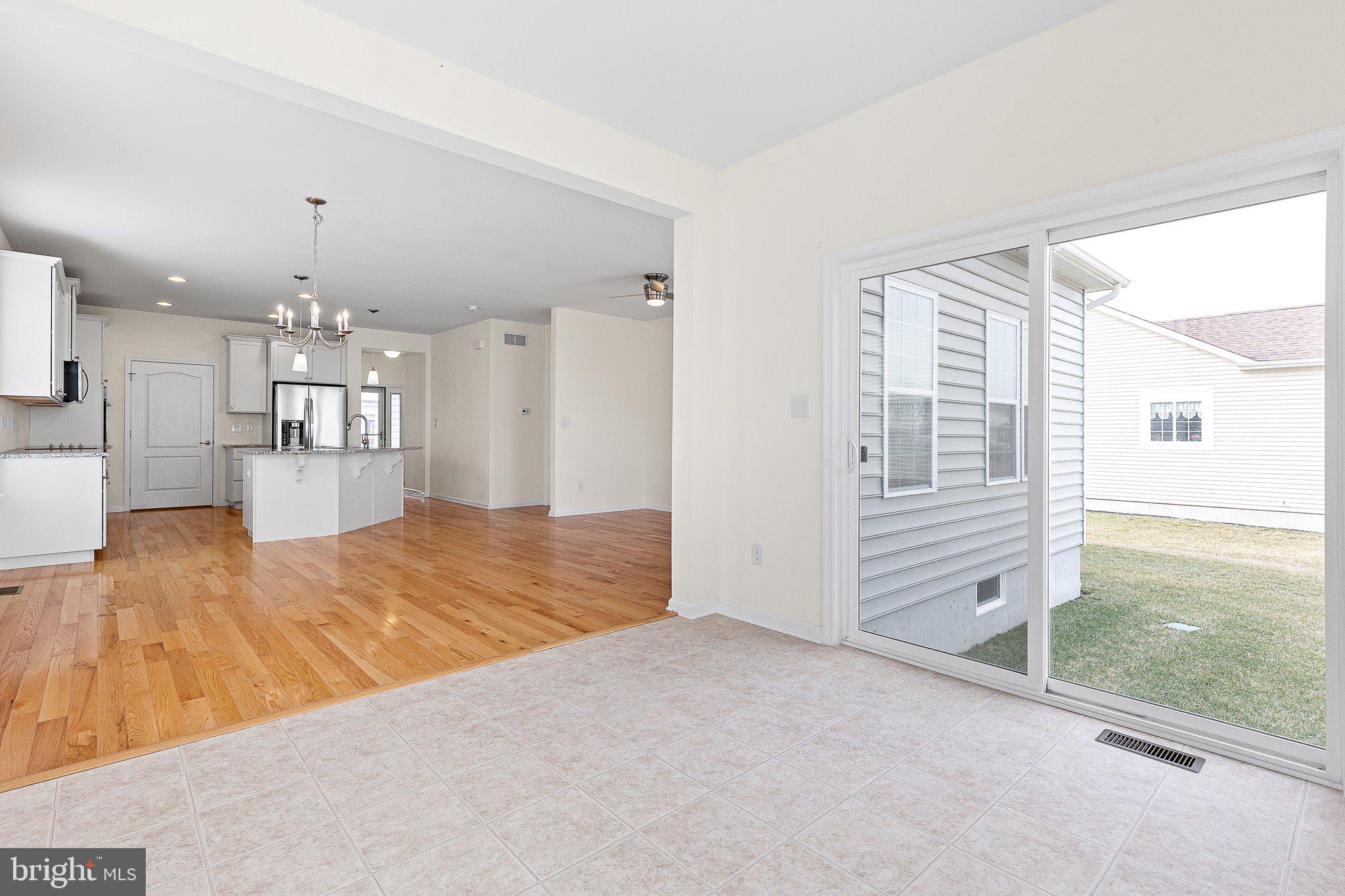 647 Vivaldi Drive Middletown, DE 19709 - Photo 18 of 38 wooden floor in an empty room with a window