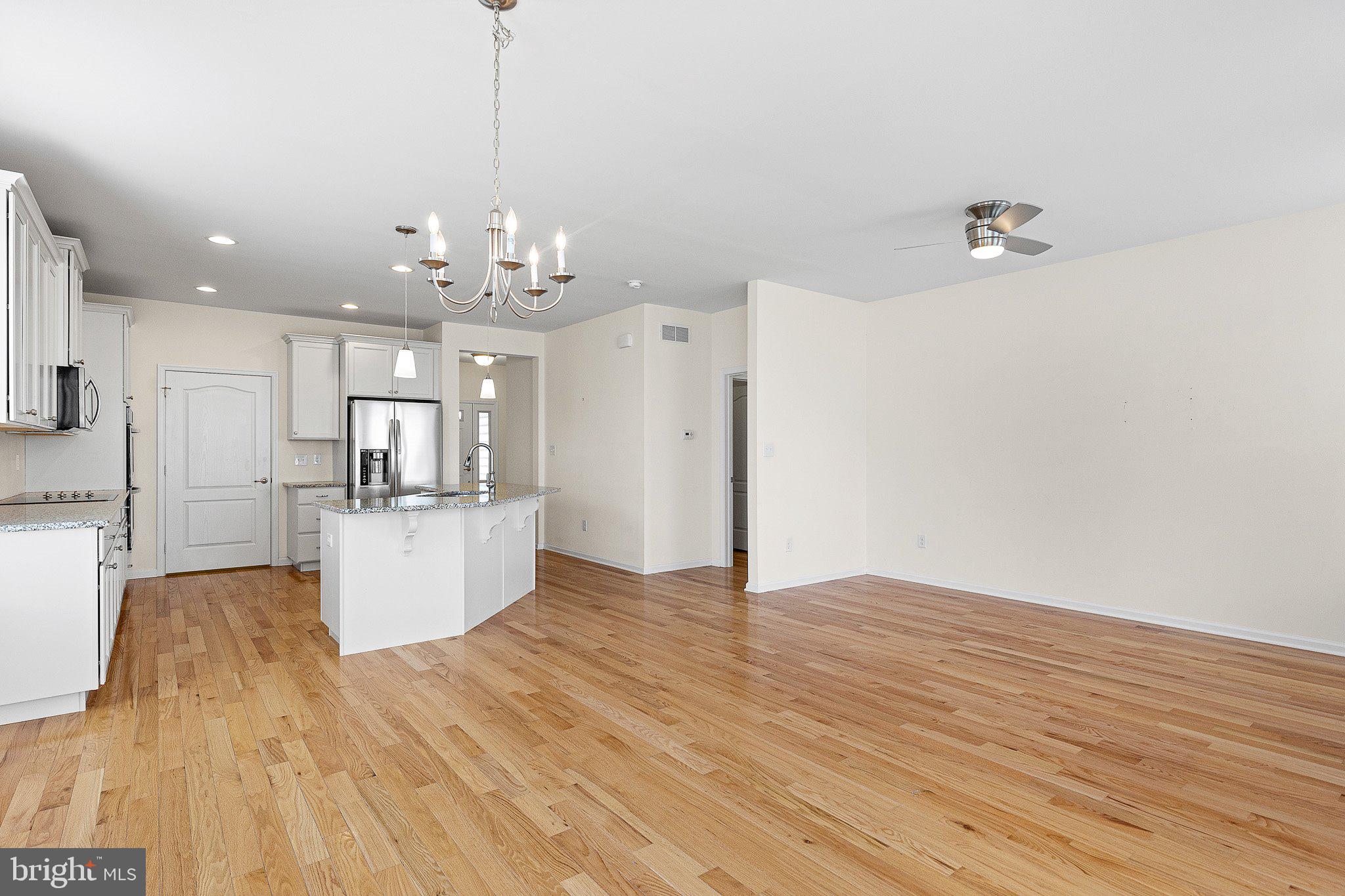 647 Vivaldi Drive Middletown, DE 19709 - Photo 19 of 38 a view of a kitchen with kitchen island wooden floor center island and stainless steel appliances
