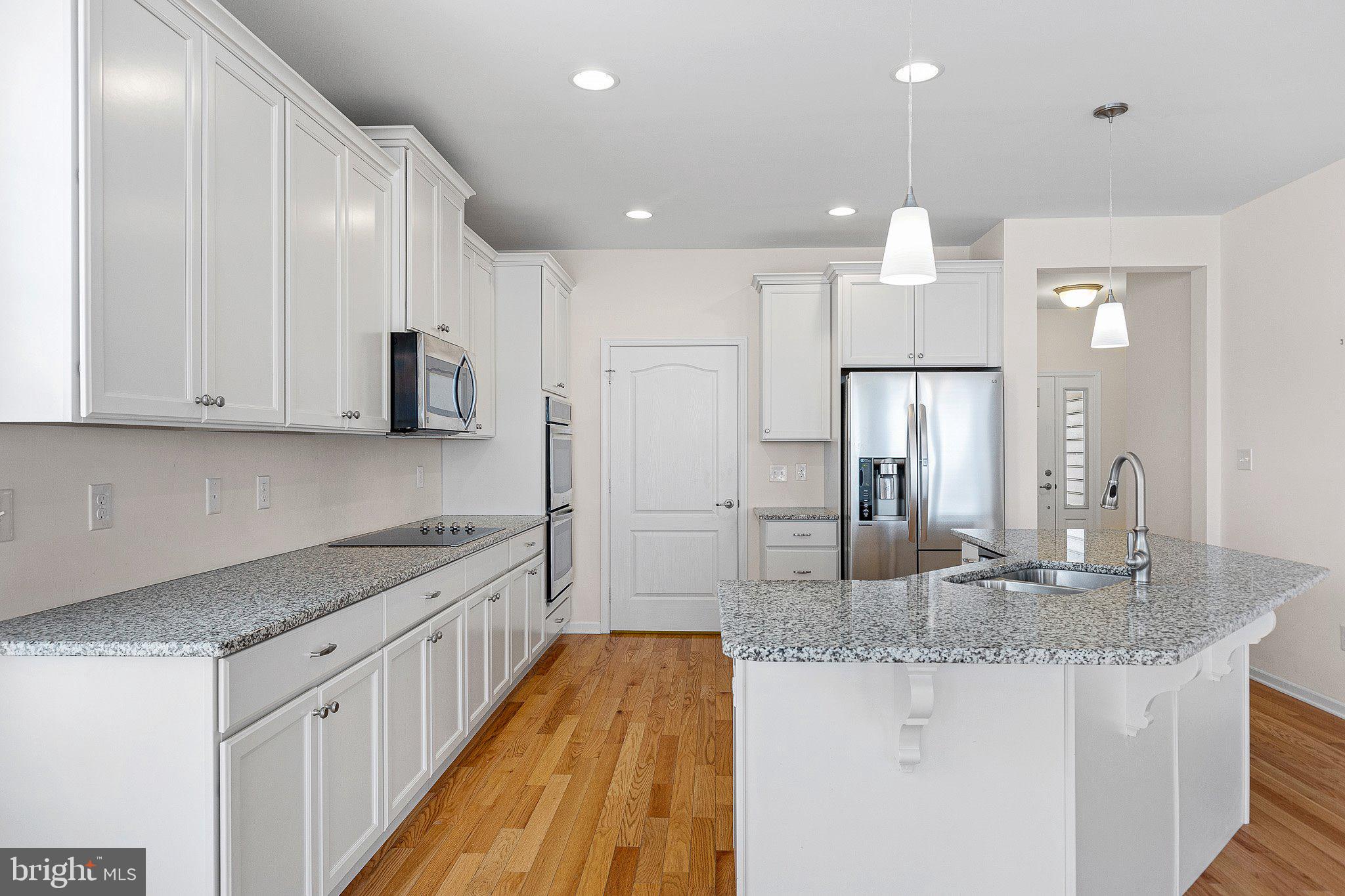 647 Vivaldi Drive Middletown, DE 19709 - Photo 20 of 38 a kitchen with stainless steel appliances granite countertop a sink and cabinets