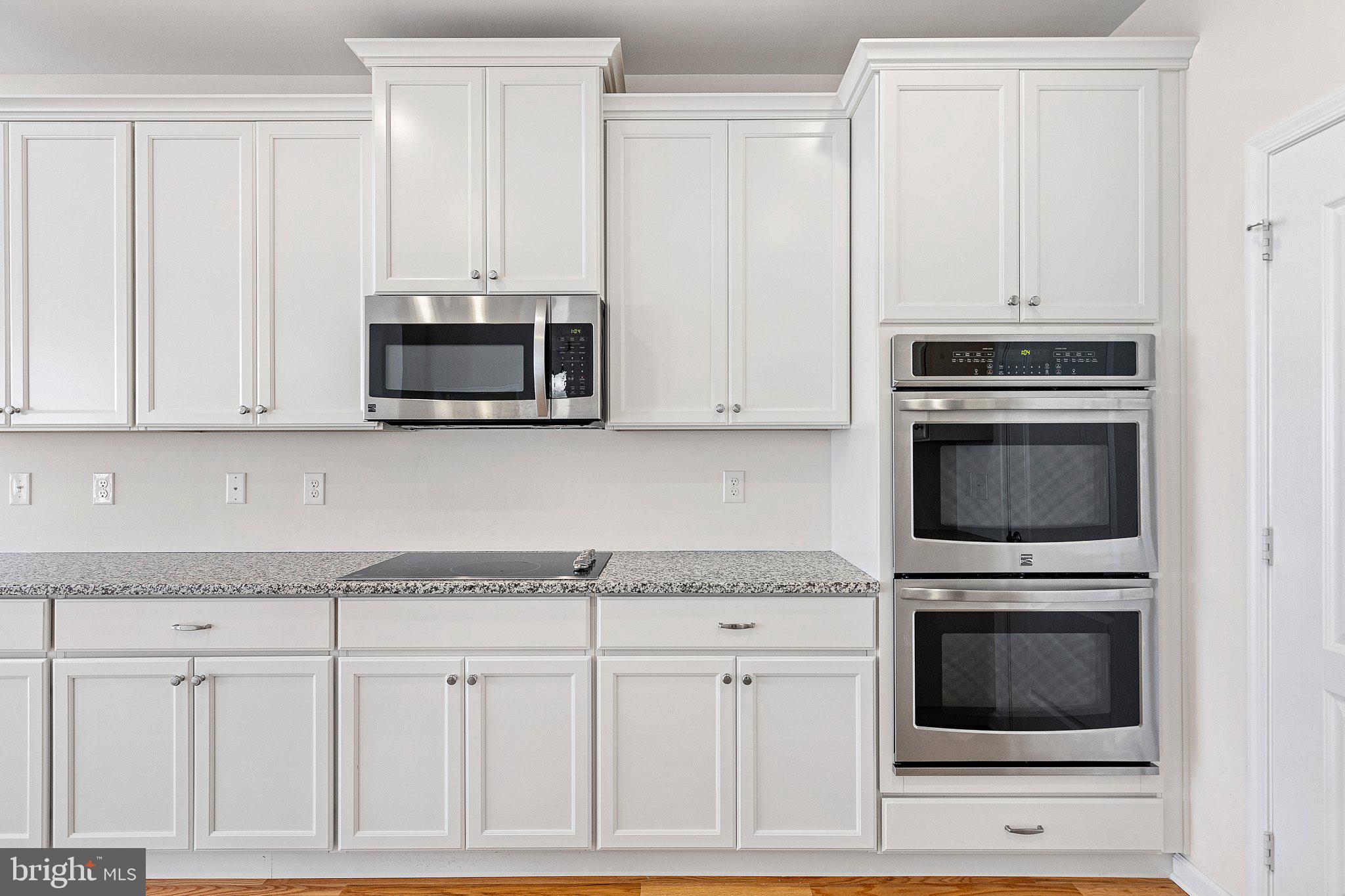 647 Vivaldi Drive Middletown, DE 19709 - Photo 21 of 38 a kitchen with granite countertop white cabinets and stainless steel appliances