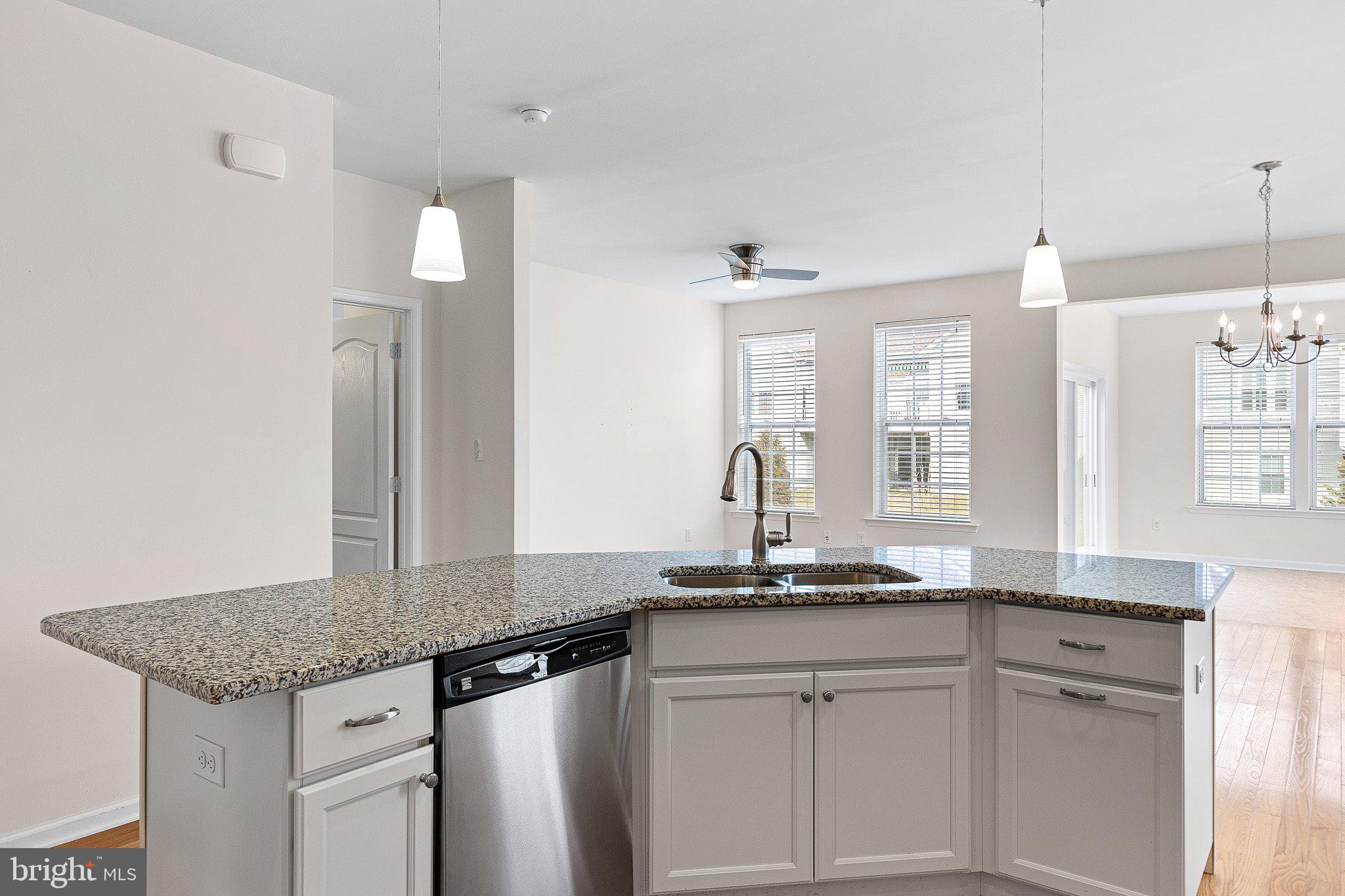 647 Vivaldi Drive Middletown, DE 19709 - Photo 22 of 38 a kitchen with granite countertop a sink cabinets and stainless steel appliances