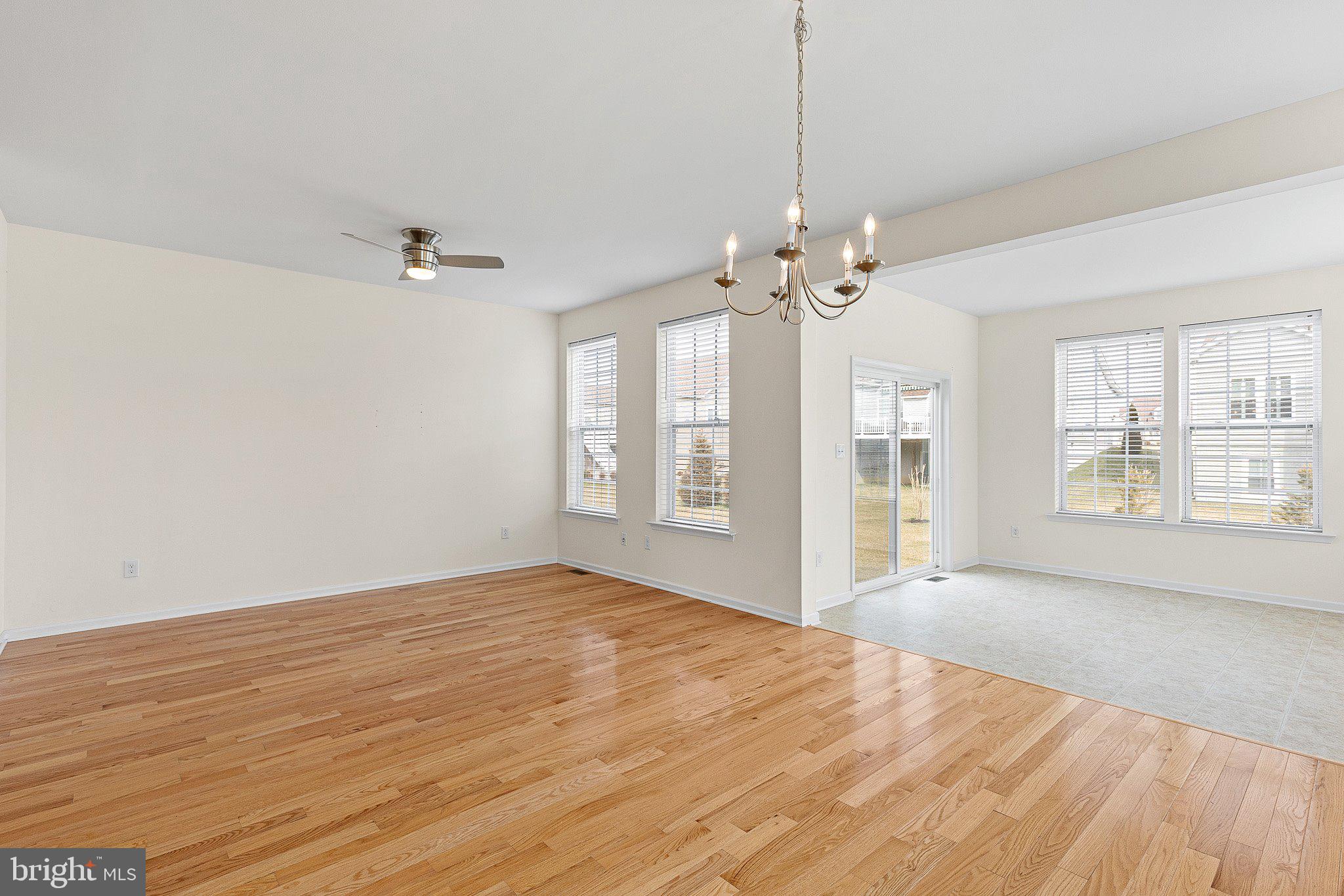 647 Vivaldi Drive Middletown, DE 19709 - Photo 3 of 38 a view of a livingroom with a chandelier fan and windows
