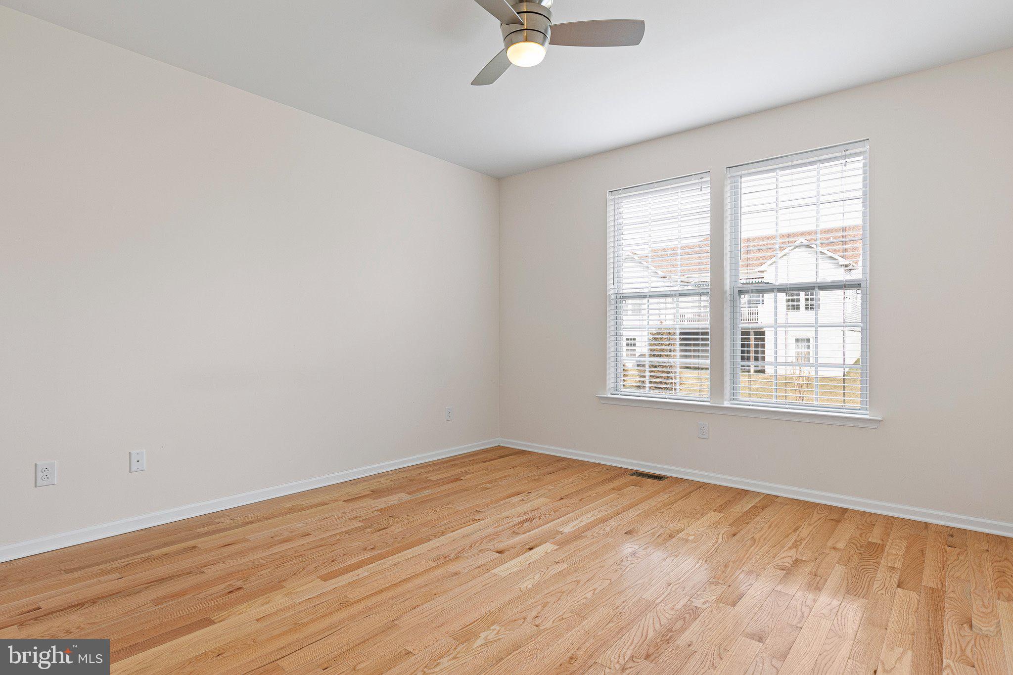 647 Vivaldi Drive Middletown, DE 19709 - Photo 7 of 38 a view of an empty room with wooden floor and a window