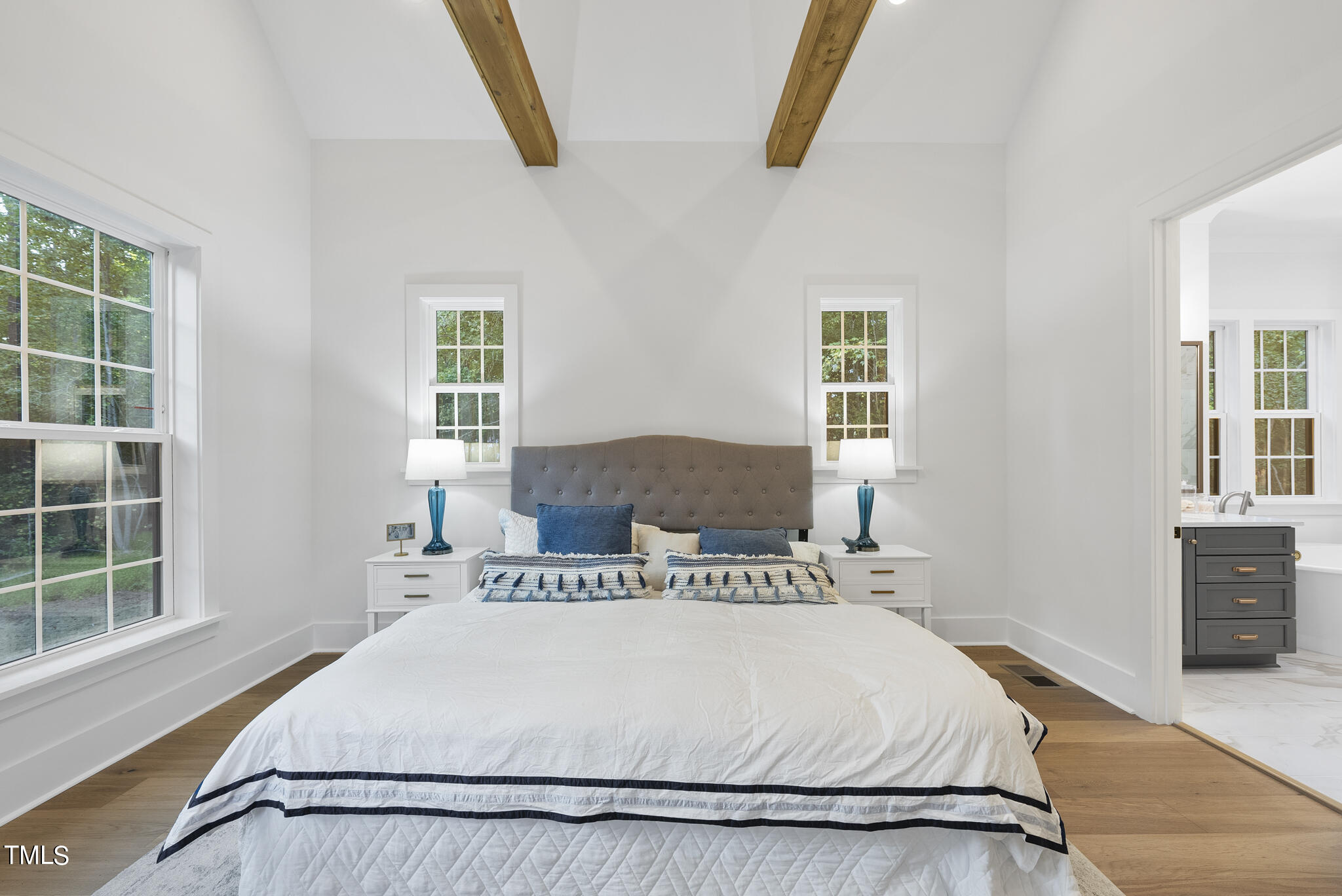 13541 Old Creedmoor Road Wake Forest, NC 27587 - Photo 12 of 41 a bedroom with a bed and wooden floor