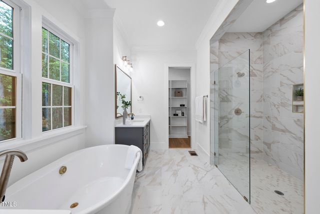 a bathroom with a tub sink and shower