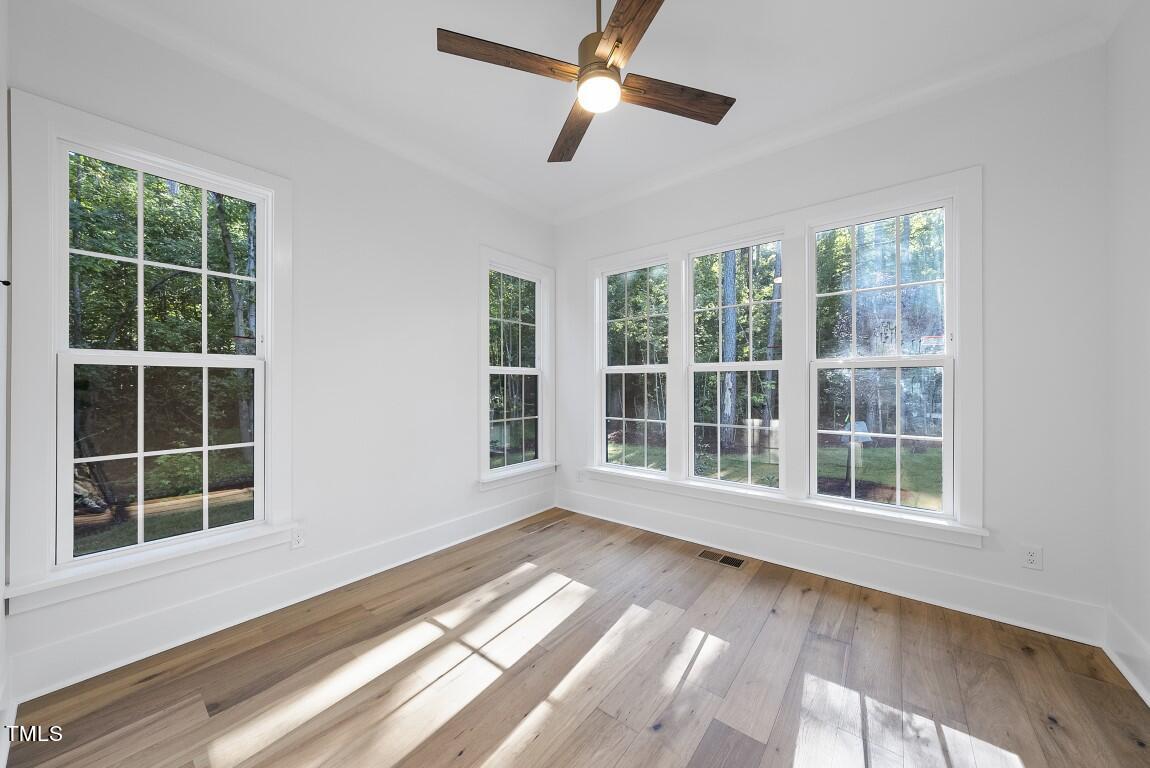 13541 Old Creedmoor Road Wake Forest, NC 27587 - Photo 17 of 41 a view of an empty room with a window and wooden floor