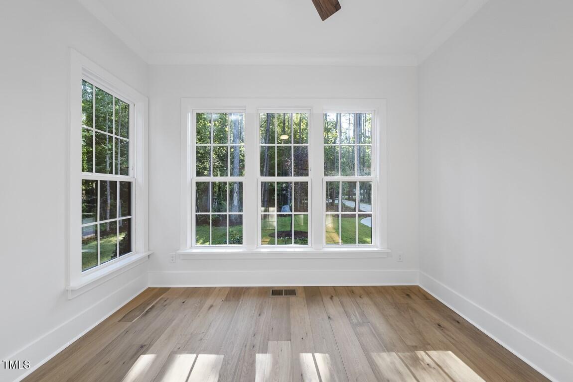 13541 Old Creedmoor Road Wake Forest, NC 27587 - Photo 18 of 41 an empty room with wooden floor and windows
