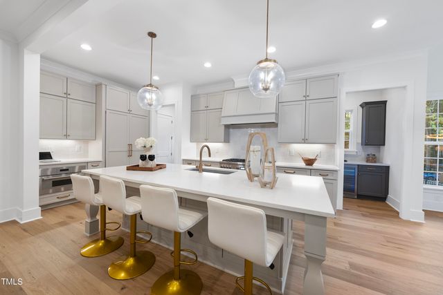 a large kitchen with a table and chairs