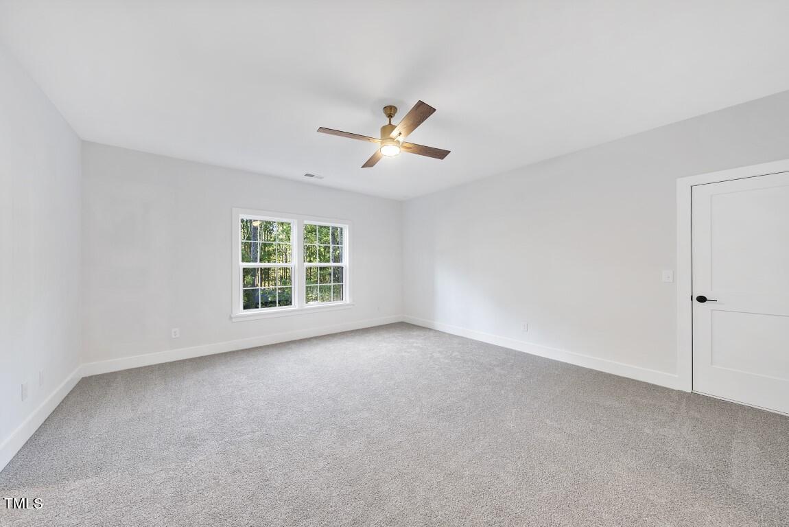 13541 Old Creedmoor Road Wake Forest, NC 27587 - Photo 21 of 41 a view of a room with a ceiling fan and a window