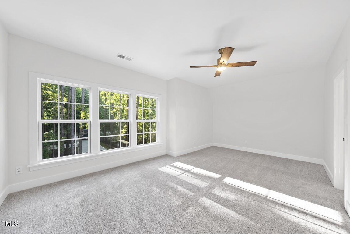 13541 Old Creedmoor Road Wake Forest, NC 27587 - Photo 24 of 41 an empty room with a window and a ceiling fan