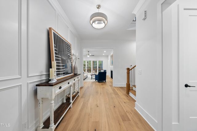 a view of a livingroom with wooden floor and furniture