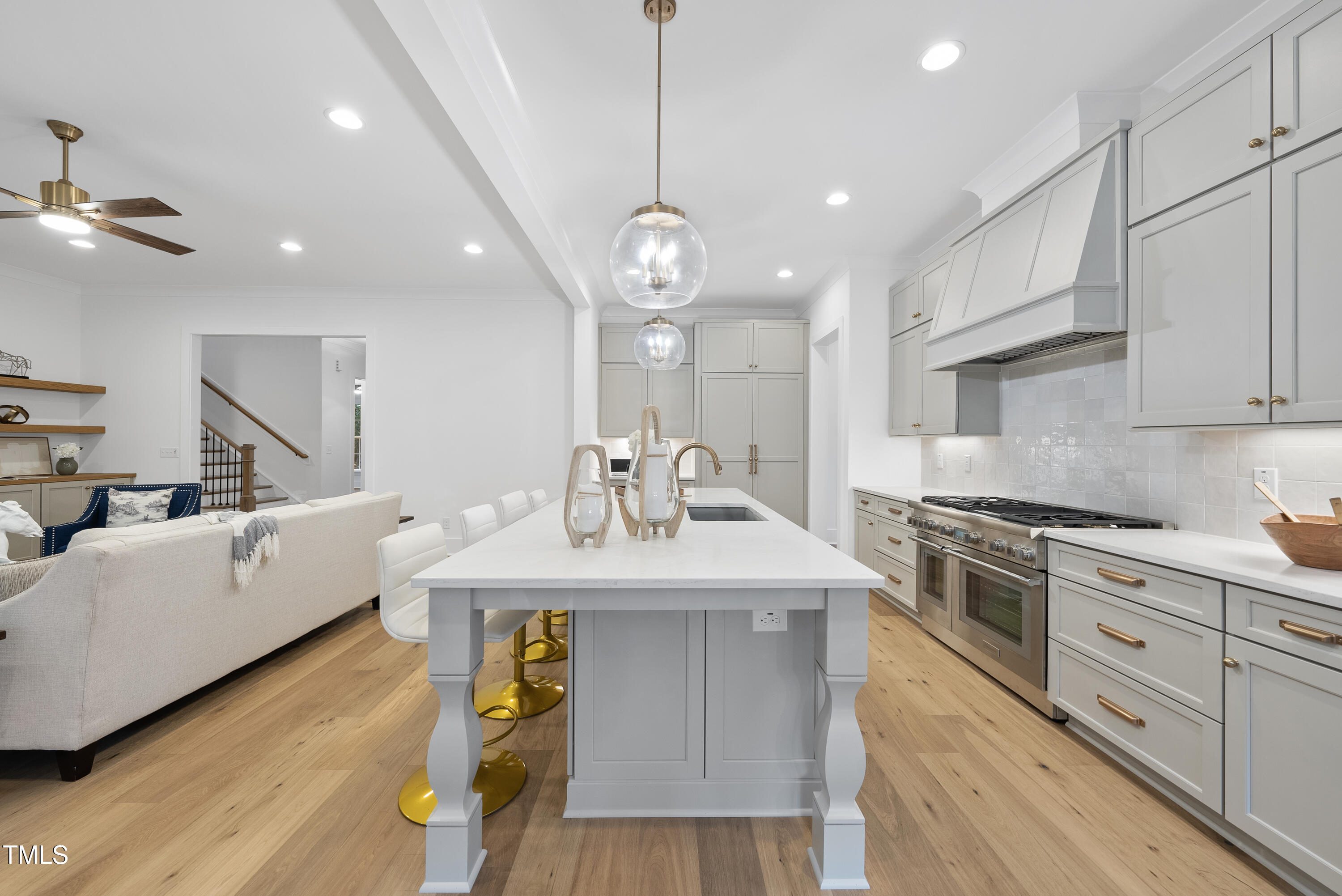 13541 Old Creedmoor Road Wake Forest, NC 27587 - Photo 3 of 41 a kitchen with kitchen island a sink stainless steel appliances and wooden floor