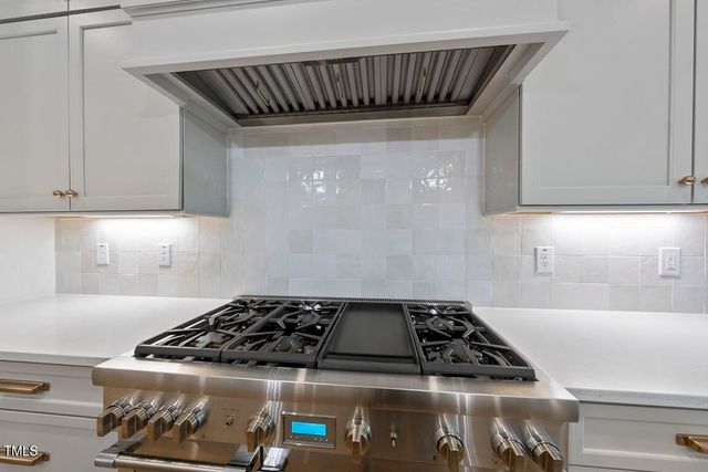 a kitchen with a stove and a cabinets