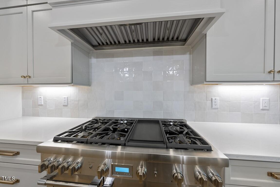 13541 Old Creedmoor Road Wake Forest, NC 27587 - Photo 5 of 41 a kitchen with a stove and a cabinets