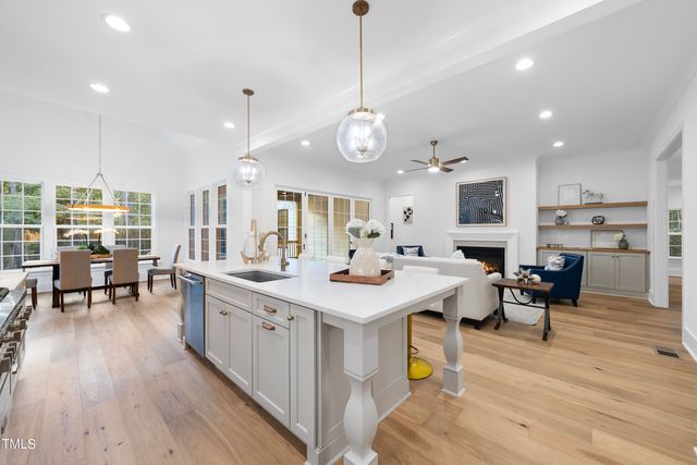 a large kitchen with a table and chairs