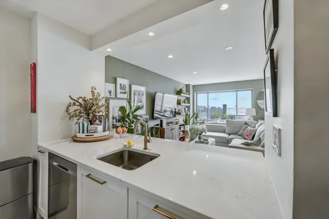 a kitchen with stainless steel appliances a sink and a refrigerator