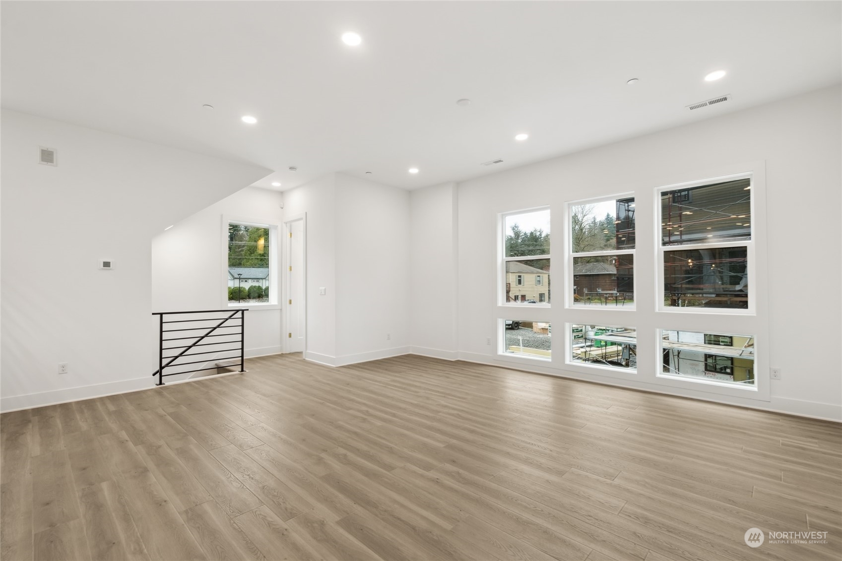 9919 Northeast 189th Street, Unit D Bothell, WA 98011 - Photo 11 of 23 an empty room with wooden floor and windows