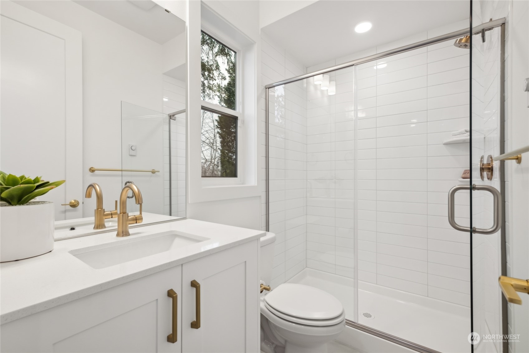 9919 Northeast 189th Street, Unit D Bothell, WA 98011 - Photo 8 of 23 a bathroom with a shower sink vanity mirror and toilet