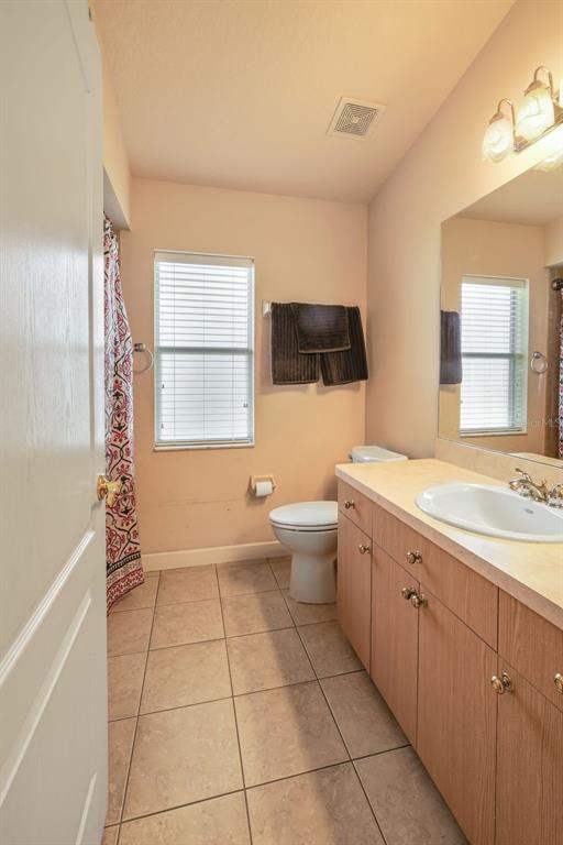 3362 Cedar Crest Loop Spring Hill, FL 34609 - Photo 24 of 57 a spacious bathroom with a double vanity sink toilet mirror and bathtub